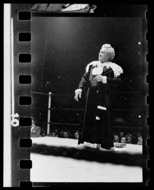 Gorgeous George, full-length portrait, standing in wrestling ring, facing left
